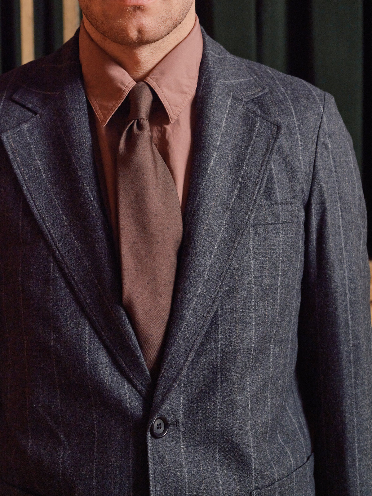 Grey pinstripe wool suit jacket worn with a pink shirt and brown wool tie