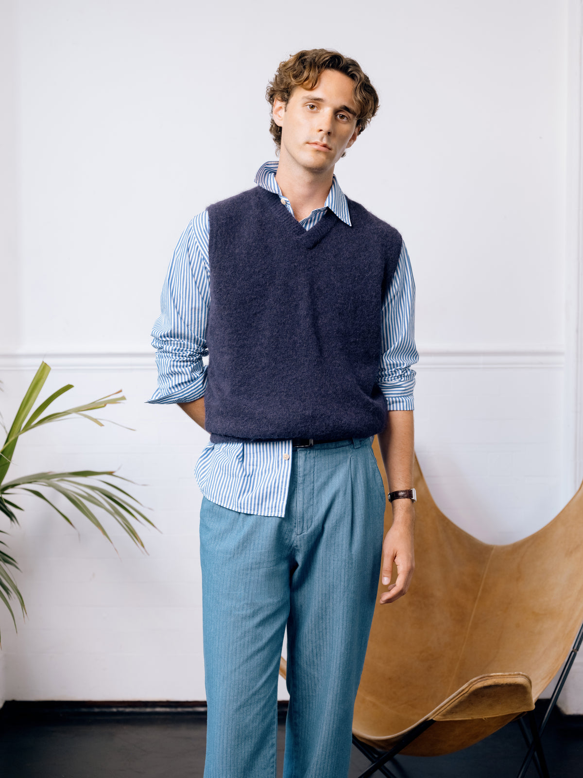Purple marl knitted vest over a blue striped New York Special shirt with pale blue corduroy trousers.