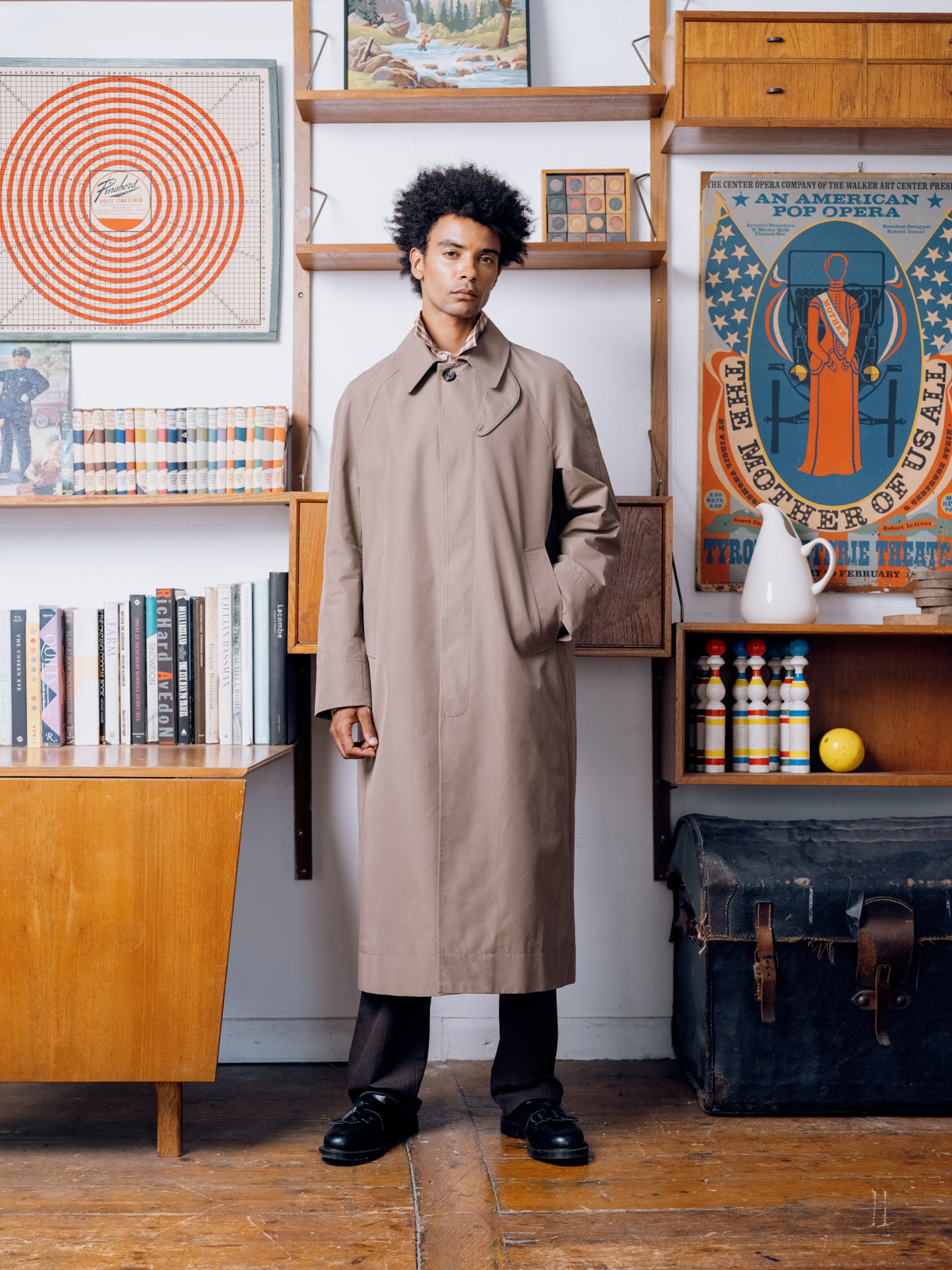 Khaki Lothian coat worn open over brown pleated trousers and black Gibson shoes.