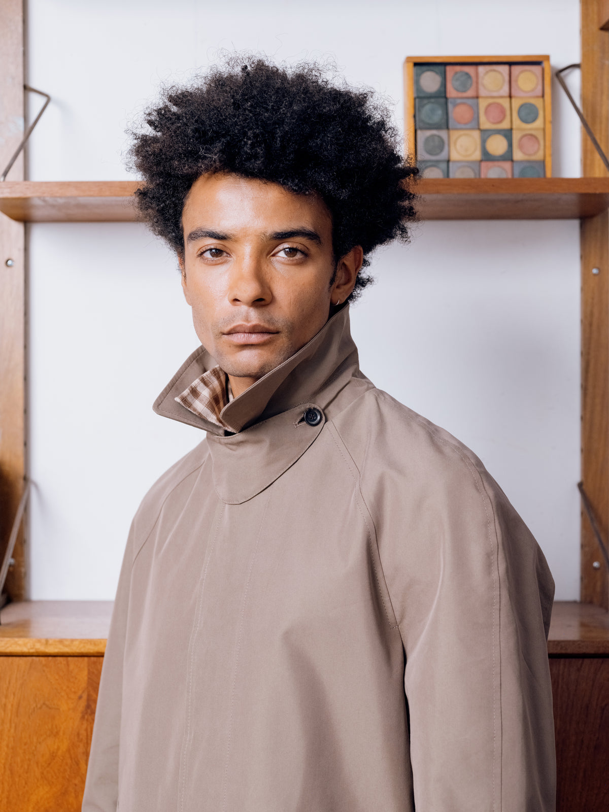 Close portrait, khaki Lothian coat worn with the collar turned up over a brown check shirt.