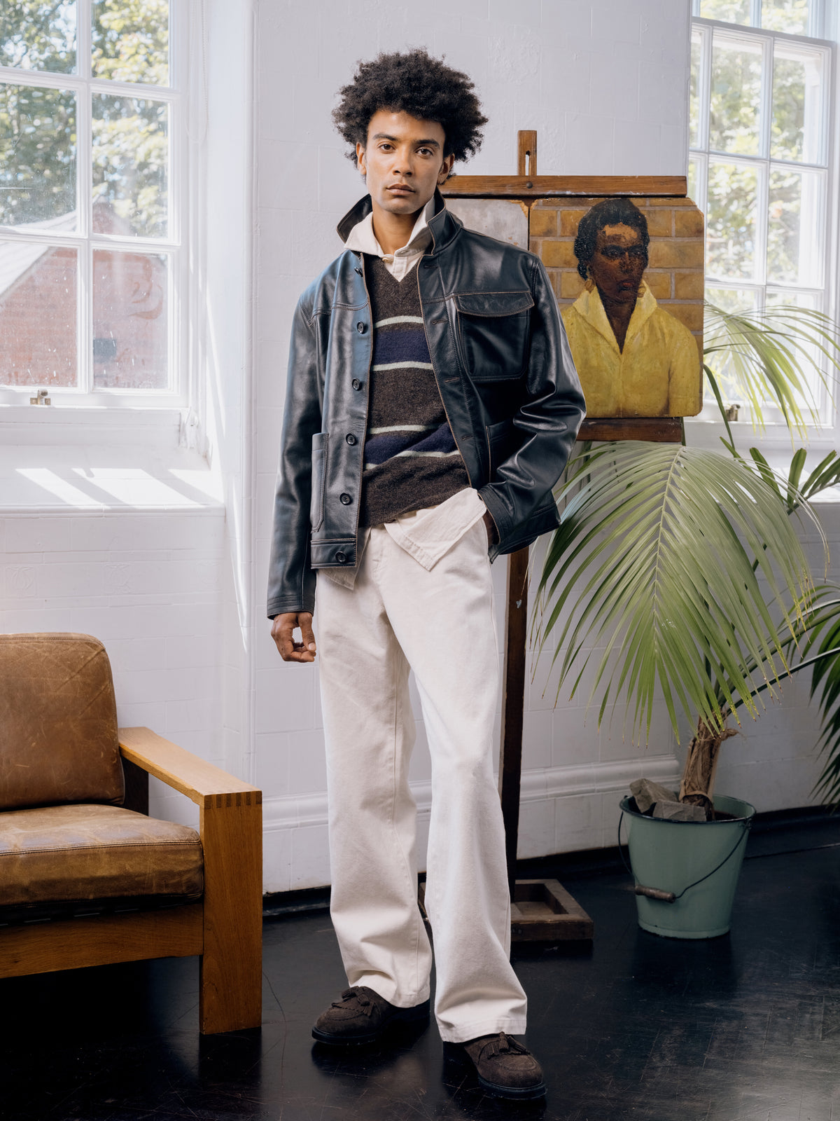 Black leather Hardwick jacket over a striped jumper with ecru trousers.