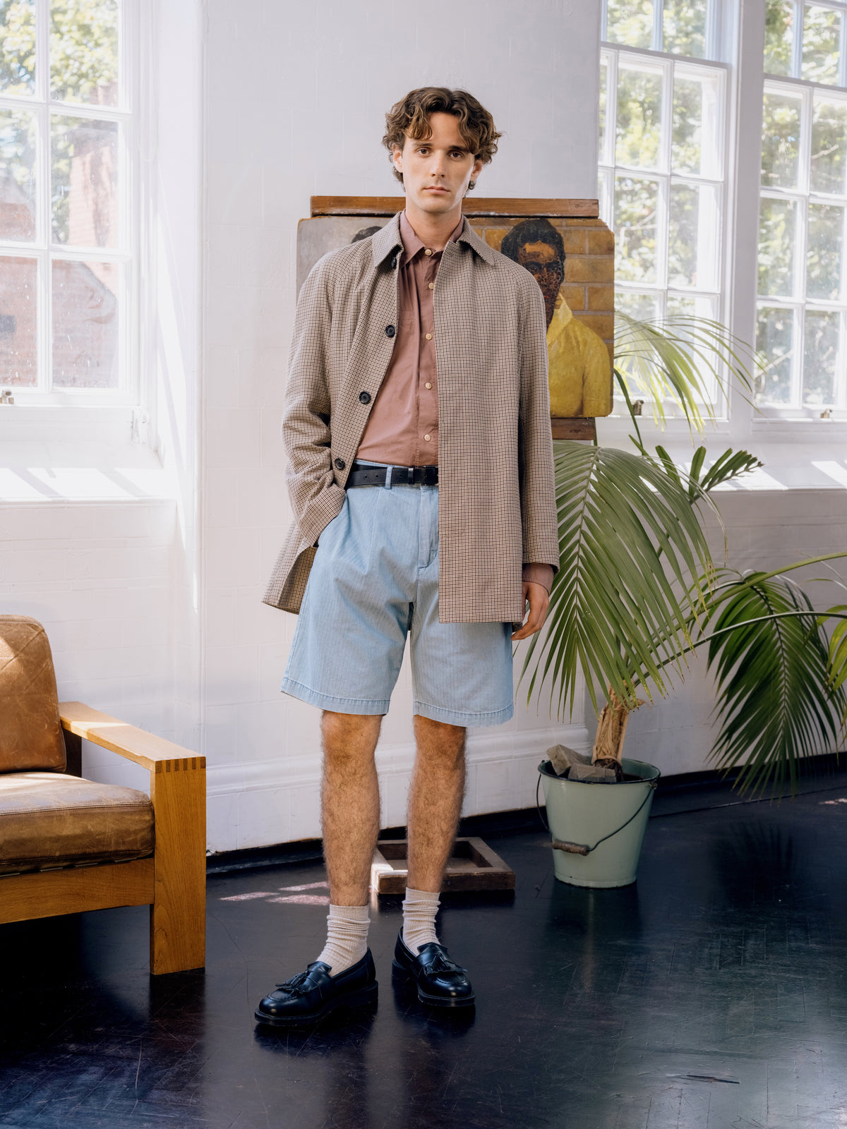 Houndstooth Crosby coat over a pink Corby shirt with indigo pleated shorts and black tassel loafers.